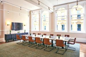 a conference room with a long table and chairs at The Grand Hotel Birmingham in Birmingham