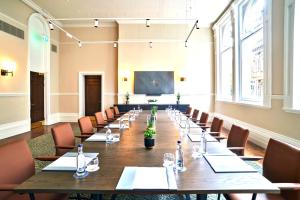 a large conference room with a long table and chairs at The Grand Hotel Birmingham in Birmingham