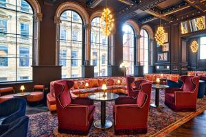 a lobby with couches and tables and windows at The Grand Hotel Birmingham in Birmingham