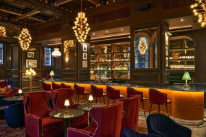 a bar at a restaurant with chairs and tables at The Grand Hotel Birmingham in Birmingham