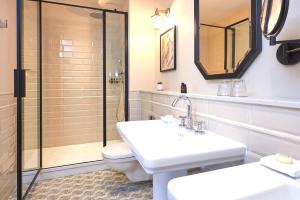a bathroom with a toilet and a sink and a shower at The Grand Hotel Birmingham in Birmingham
