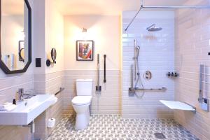 a bathroom with a toilet and a sink and a shower at The Grand Hotel Birmingham in Birmingham