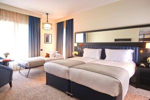 a hotel room with two beds and a large window at The Grand Hotel Birmingham in Birmingham