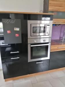 a kitchen with a stove and a microwave at Ferienhaus Mühlfeldner in Laufen