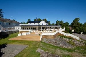 a large house with a staircase leading up to it at Arkösunds Hotell in Arkösund