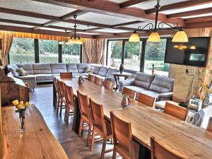 a living room with a large wooden table and chairs at Ferienhaus im Wiesengrund in Simmerath
