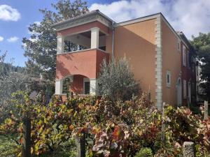 a house with a garden in front of it at Apartments Rolovina in Tivat