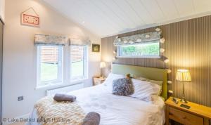 a bedroom with a bed with two pillows on it at Sheffield Pike Lodge in Windermere
