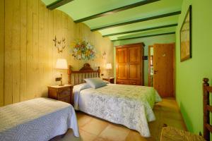 A bed or beds in a room at Casa Rural Can Coll