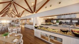 a restaurant with a buffet with tables and chairs at Valamar Bellevue Resort in Rabac