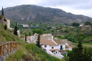 a village on a hill with a mountain in the background at Cehegin Old Town House in Cehegín