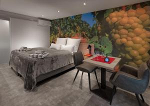 a bedroom with a bed and a painting of grapes at WeinMotel Simon 1 a in Alzenau in Unterfranken