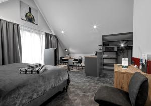 a bedroom with a bed and a desk and a chair at WeinMotel Simon 1 a in Alzenau