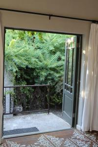 an open door to a garden with a plant at GABRIELLA'S in Riebeek-Kasteel