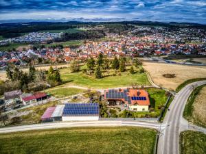 an aerial view of a city with a house with solar panels at Ferienwohnung Amelie in Wenzenbach