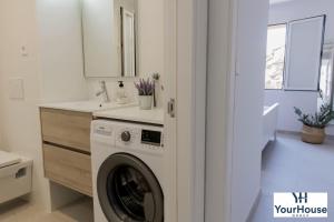 a kitchen with a washing machine in a bathroom at YourHouse Es Niu, apartment in Puerto de Sóller in Sóller