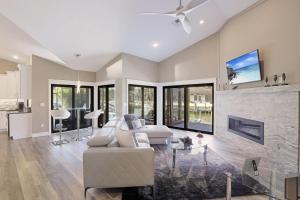 a living room with a couch and a fireplace at Stunning home with pool, dock and direct gulf access in Marco Island
