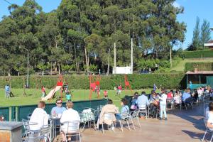 a crowd of people sitting in chairs in a park at Apartamentos Marina in Naveces