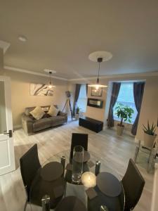 a living room with a table and chairs and a couch at River View Apartment Suite in Cork