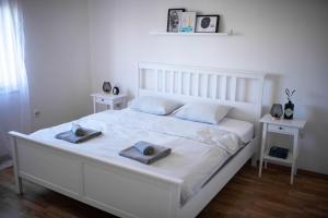 a bedroom with a white bed with two towels on it at Holiday Home Pearl in Stone with Heated Pool in Imotski +39 photos
