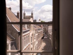 a view through a window of a city street at Hotel Au Quartier in Maastricht