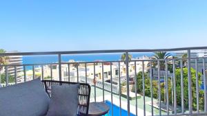 a balcony with a chair and a view of the beach at Sea Views and big balcony in Torremolinos