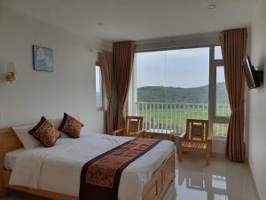1 dormitorio con cama y ventana grande en Minh Manh Hotel 2, en Pleiku