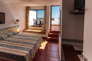 Posteľ alebo postele v izbe v ubytovaní Hostal El Dorado