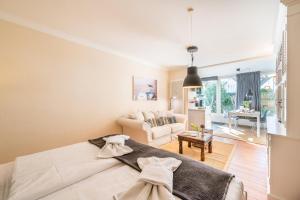 a bedroom with a bed and a living room at Villa Stranddistel Whg.1 in Binz
