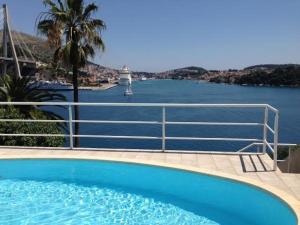 a swimming pool with a view of the water at Apartments Lozica in Dubrovnik