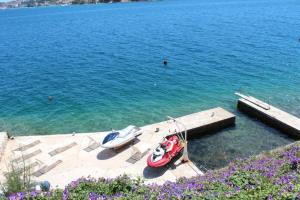 two boats are docked at a dock in the water at Apartments Lozica in Dubrovnik