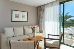 a living room with a couch and a table at Hipotels Natura Palace Adults Only in Playa Blanca