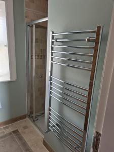 a shower stall with a glass door in a bathroom at Dromod Lodge in Dromod