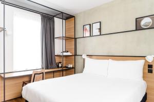 a hotel room with a bed, desk, and window at ibis Bridgwater, M5 Jct23 in Bridgwater
