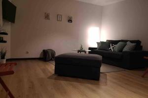 sala de estar con sofá negro y mesa en Easy comfort, en Bruselas