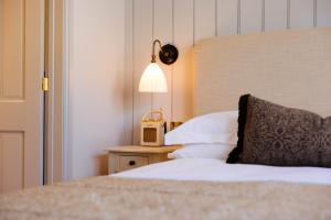 a hotel room with a bed and a table with a clock at The Yard in Bath Hotel in Bath