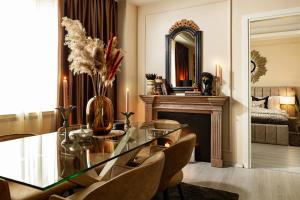 a dining room with a glass table and a mirror at Qult - The Aristocrat in Bucharest