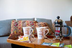 a coffee table with two cups and a coffee maker on it at Studio cosy sur l’île de Nantes / Proche Tramway in Nantes