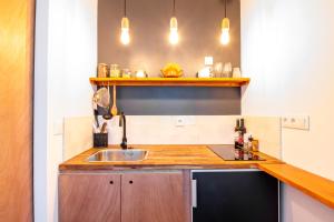 a kitchen with a sink and a counter at Studio cosy sur l’île de Nantes / Proche Tramway in Nantes