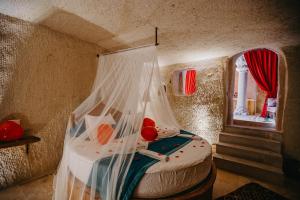 A bed or beds in a room at Prime Cappadocia Suites