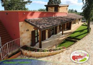 a house with a large building with a courtyard at B&B Il Casolare in Sant'Isidoro