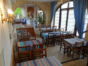 a restaurant with tables and chairs in a room at Hotel Restaurant des Thermes in Castéra-Verduzan
