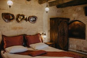 A bed or beds in a room at Prime Cappadocia Suites