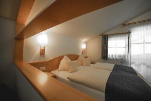Voodi või voodid majutusasutuse Hotel Landhaus Neumayr toas