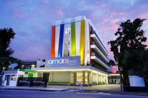 a building with a colorful facade on a street at Amaris Hotel Cirebon in Cirebon