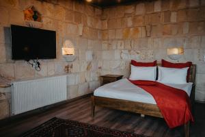 A bed or beds in a room at Prime Cappadocia Suites