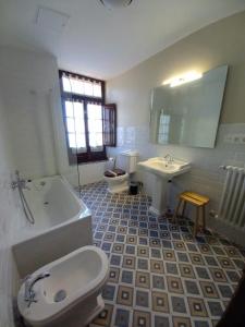 a bathroom with a toilet a sink and a bathtub at Hotel Eutimio in Lastres