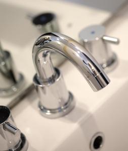 a bathroom sink with a silver faucet at Amaris Hotel Cirebon in Cirebon
