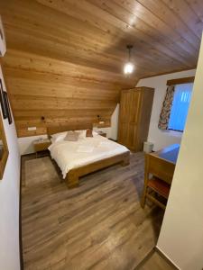 a bedroom with a bed and a wooden ceiling at FLORA HOUSE in Rastovača