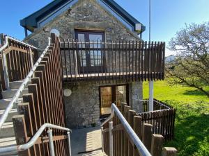 a stone house with a staircase leading up to it at Kinvara Suites in Kinvara